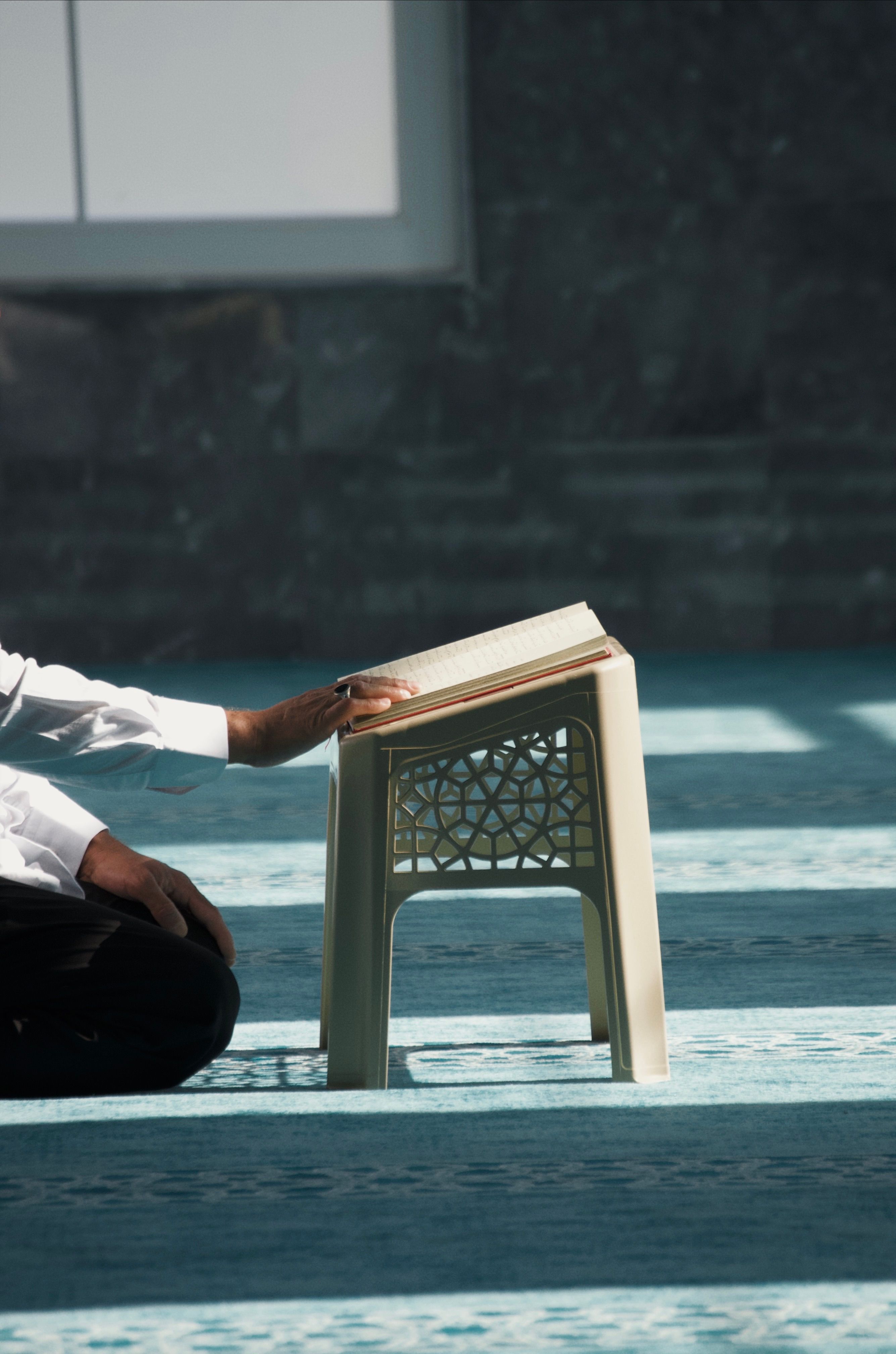 Person Reading Religious Text in Serene Environment · Free Stock Photo