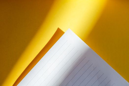 Stylish photo of lined paper on bright yellow background.