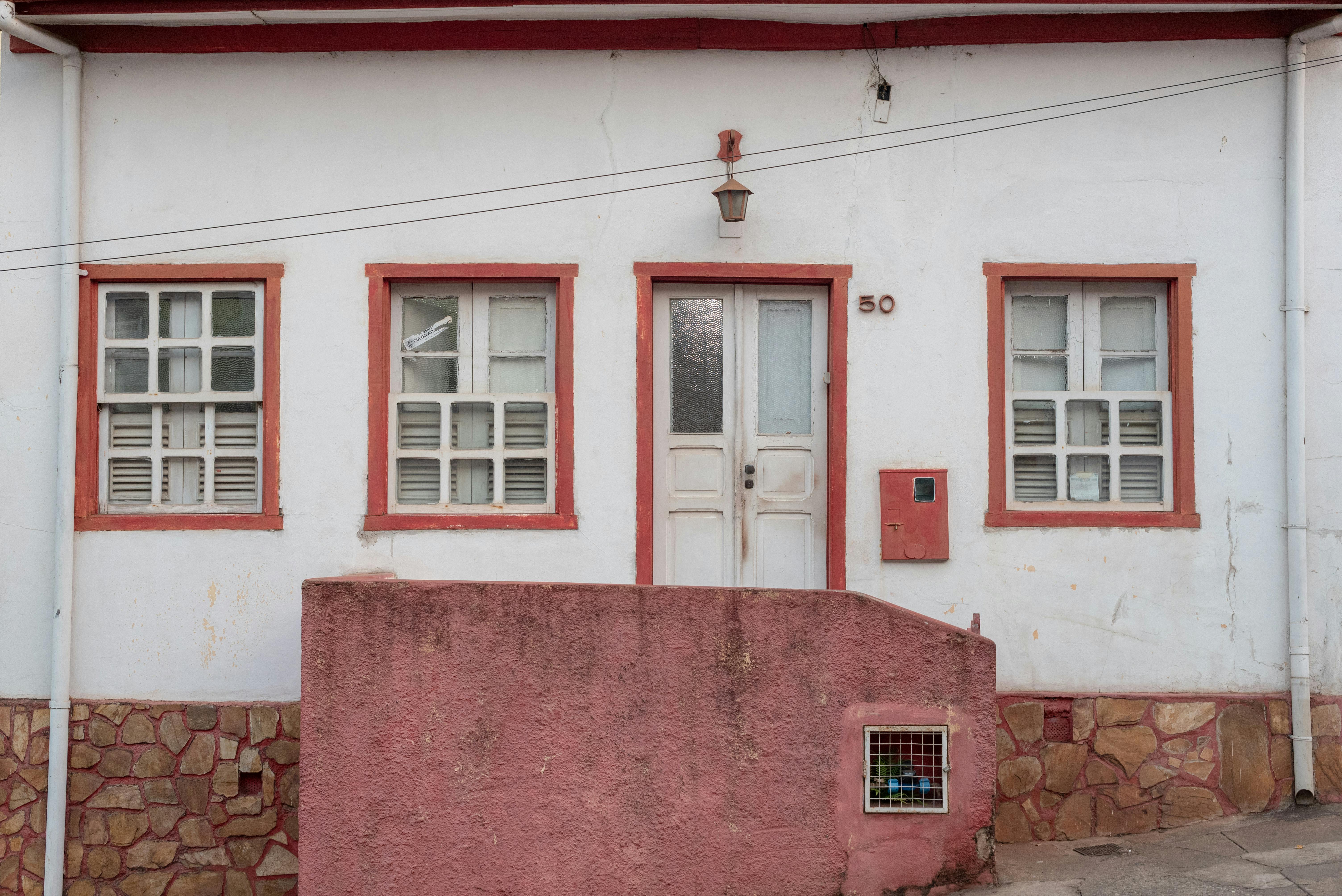 Charming colonial facade of a historic house in Sabará, showcasing traditional architecture and details.