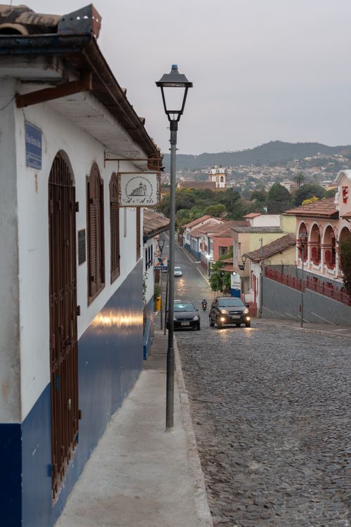 Free Cobblestone street view in historic Sabará, Brazil showcasing colonial architecture. Stock Photo