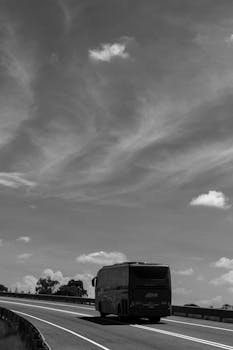 A bus travels down a winding road under clear skies in Rafael Lara Grajales, Mexico.