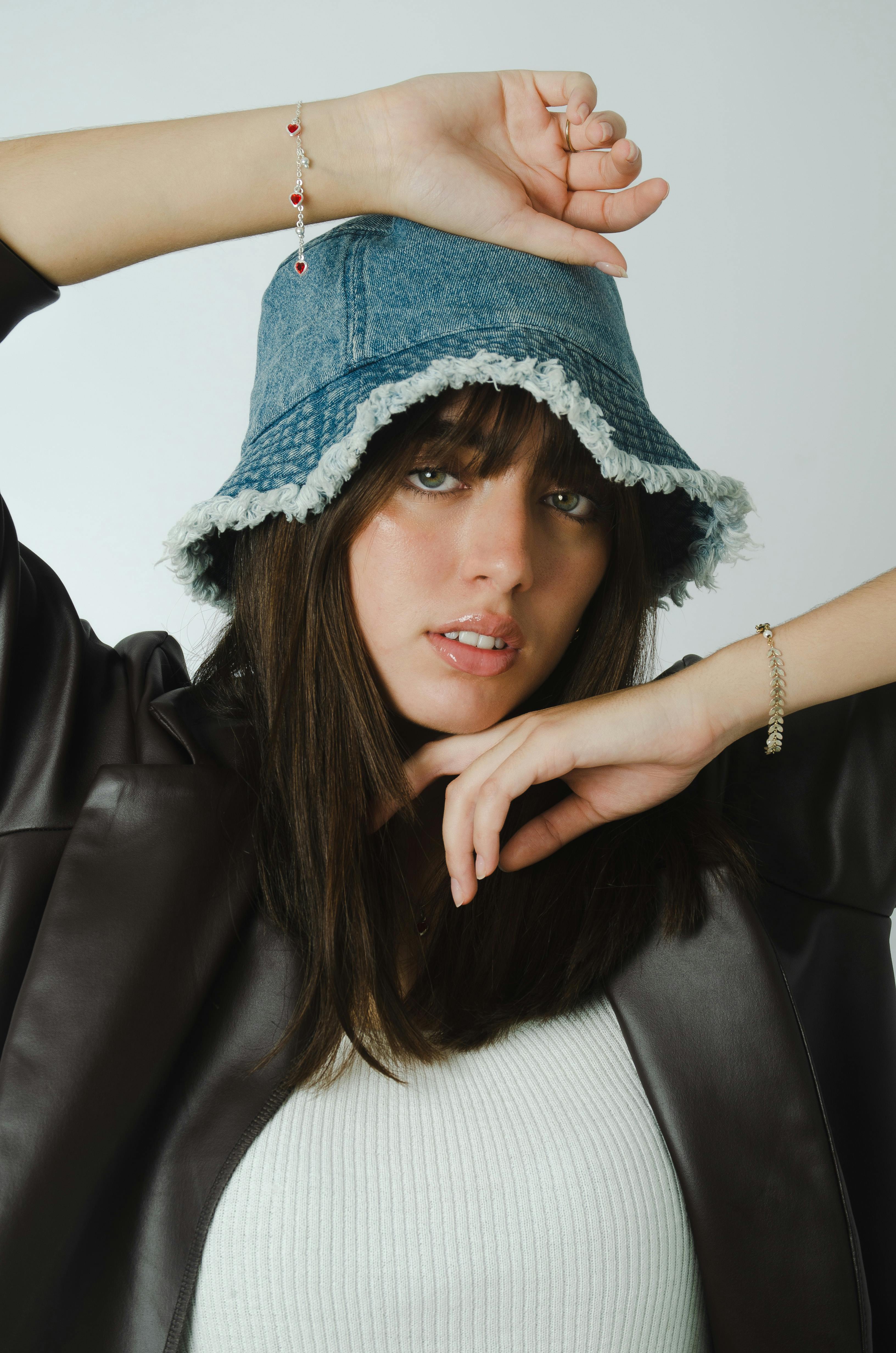 Portrait of a woman wearing a denim bucket hat, showcasing modern fashion.