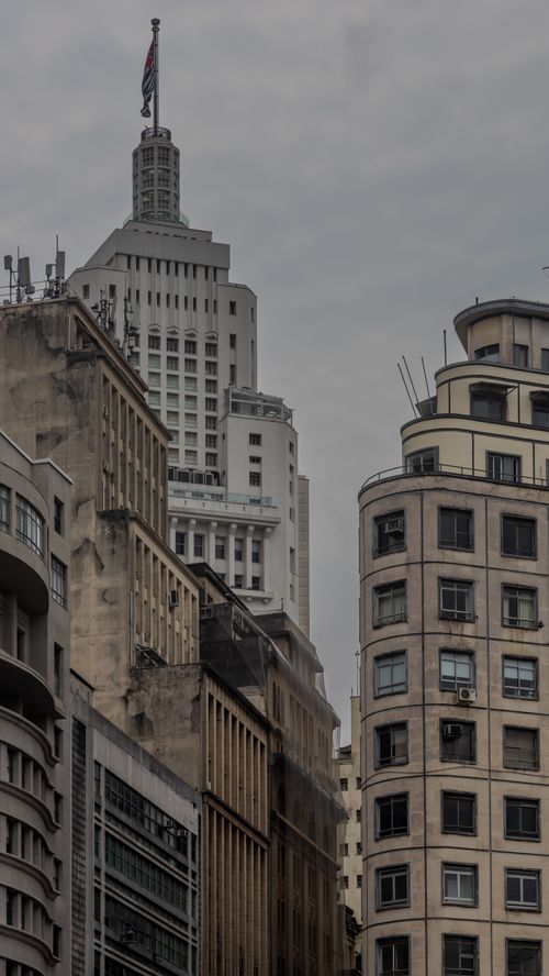 Free Skyline of historic buildings against a cloudy sky, featuring a notable tower. Stock Photo