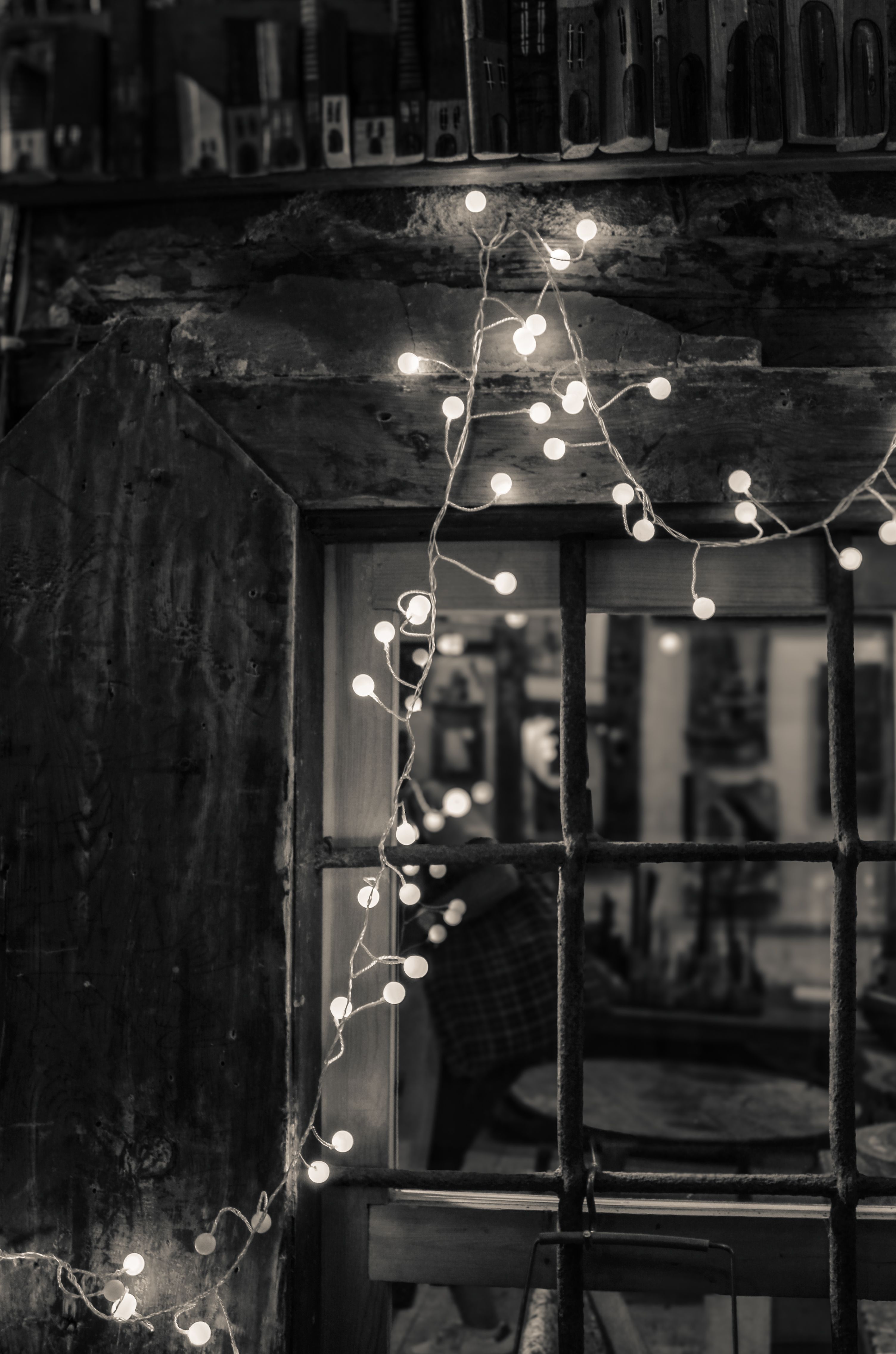 Warm fairy string lights draped along the back of a bohemian coffee bar counter