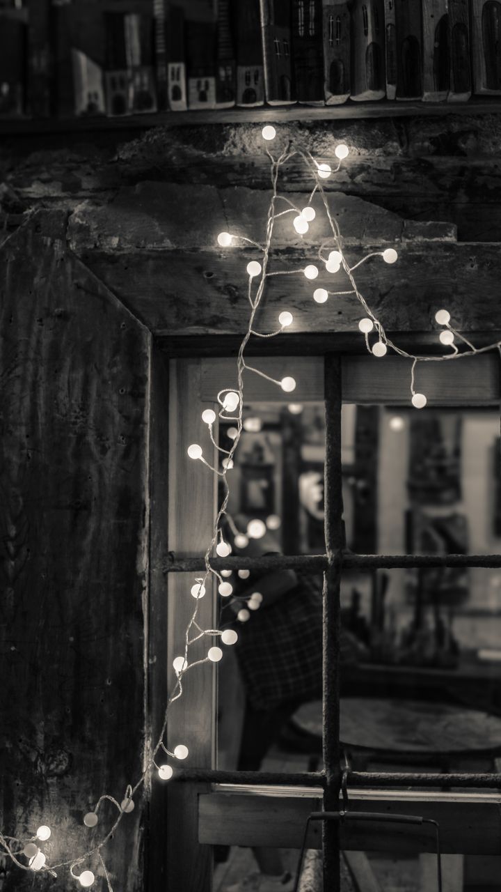 Warm fairy string lights draped along the back of a bohemian coffee bar counter