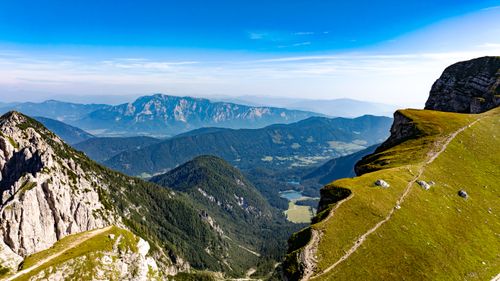 Free An breathtaking aerial view showcasing rugged mountains and lush valleys under clear blue skies. Stock Photo
