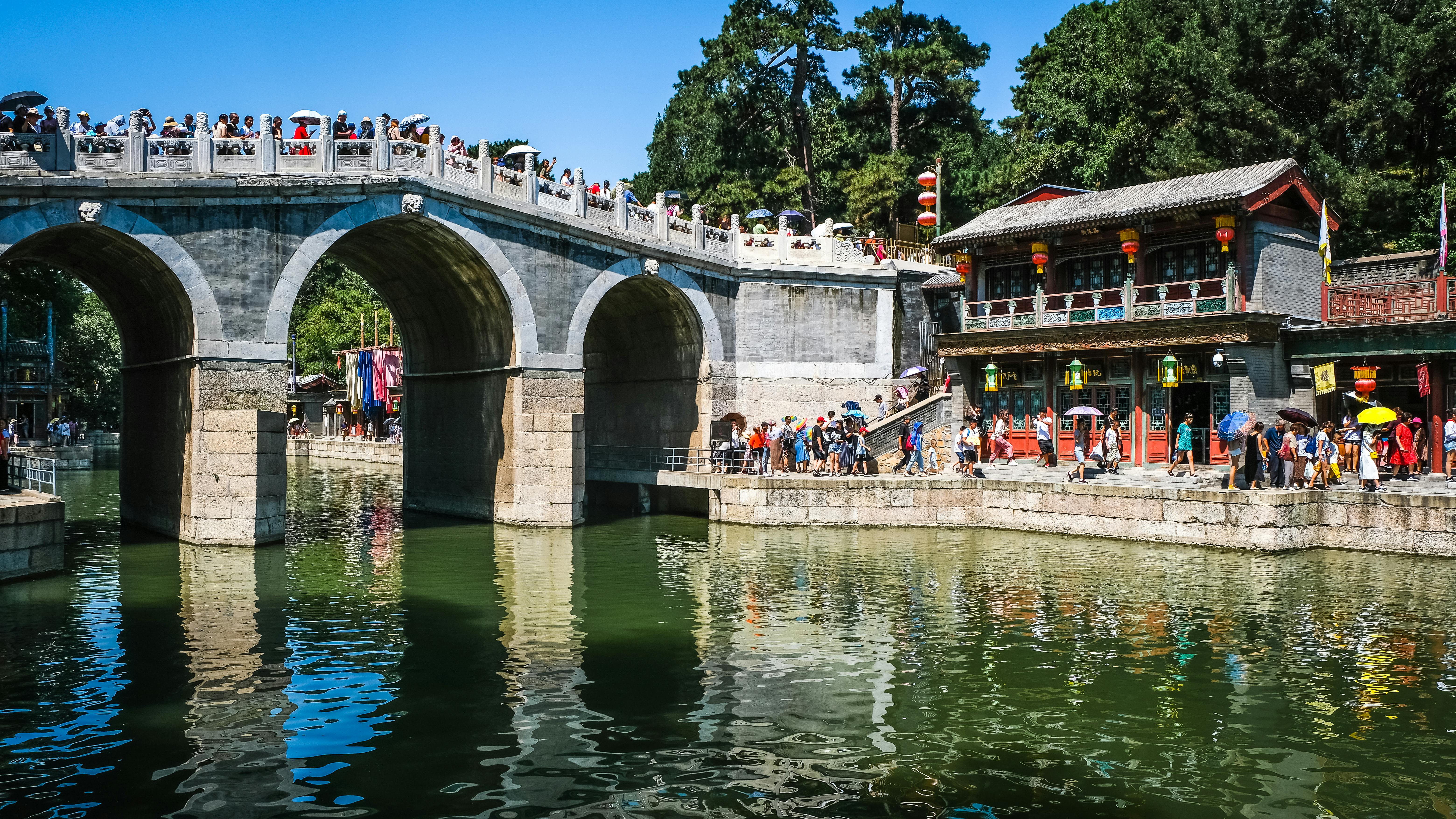 a bridge over a river full of people