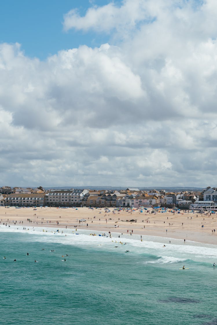 People Enjoying Summer At The Beach