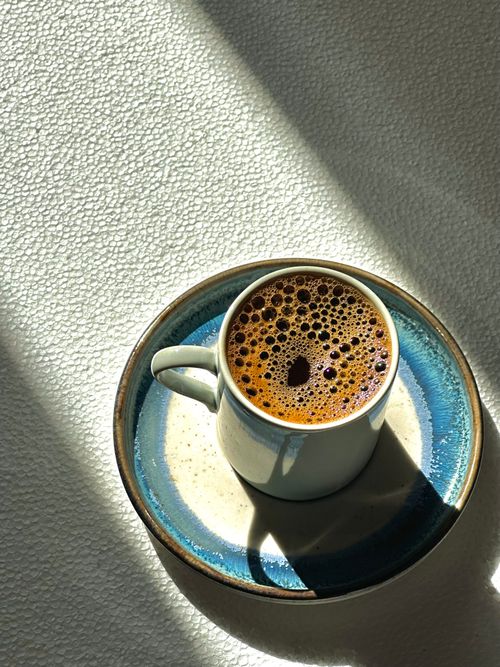 Free A warm cup of Turkish coffee in a sunlit setting on a textured surface. Stock Photo