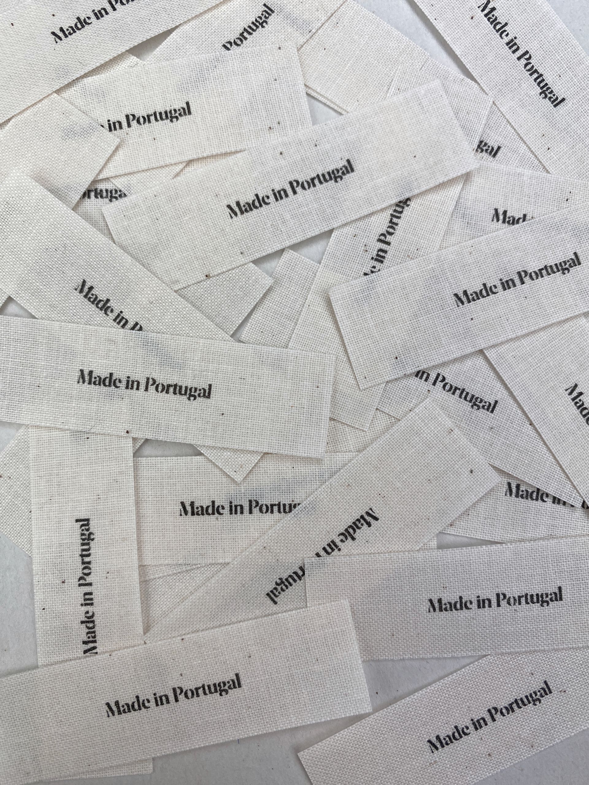 Scattered textile labels on white background