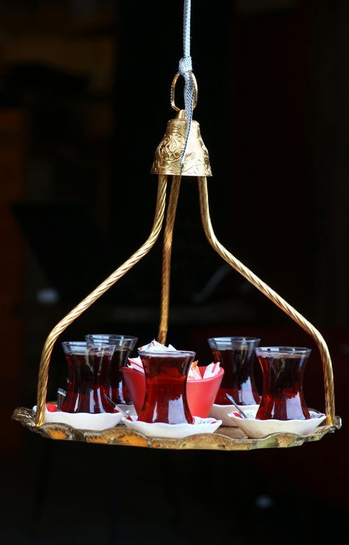 Free A Turkish tea set with glasses on a decorative brass tray, evoking cultural charm. Stock Photo