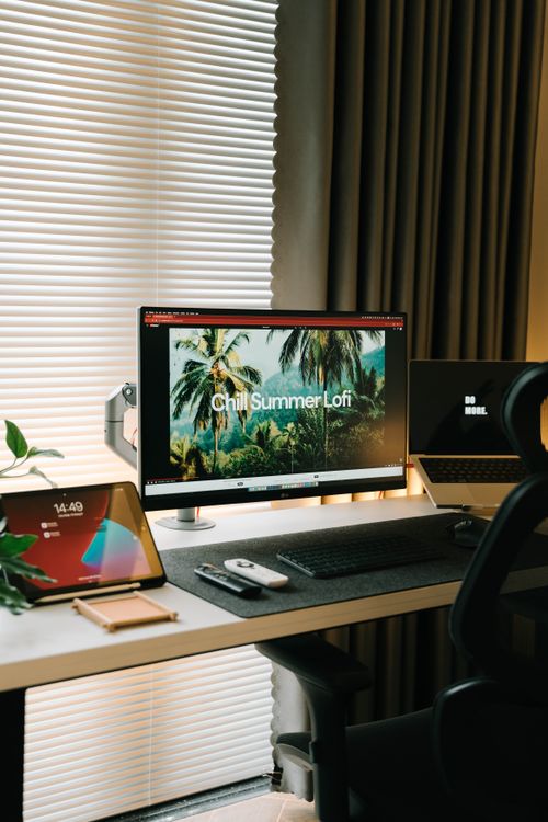 Free Stylish home office with dual monitors, tablet, and modern design elements. Stock Photo
