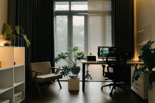A stylish home office featuring indoor plants, natural light, and a modern workspace.