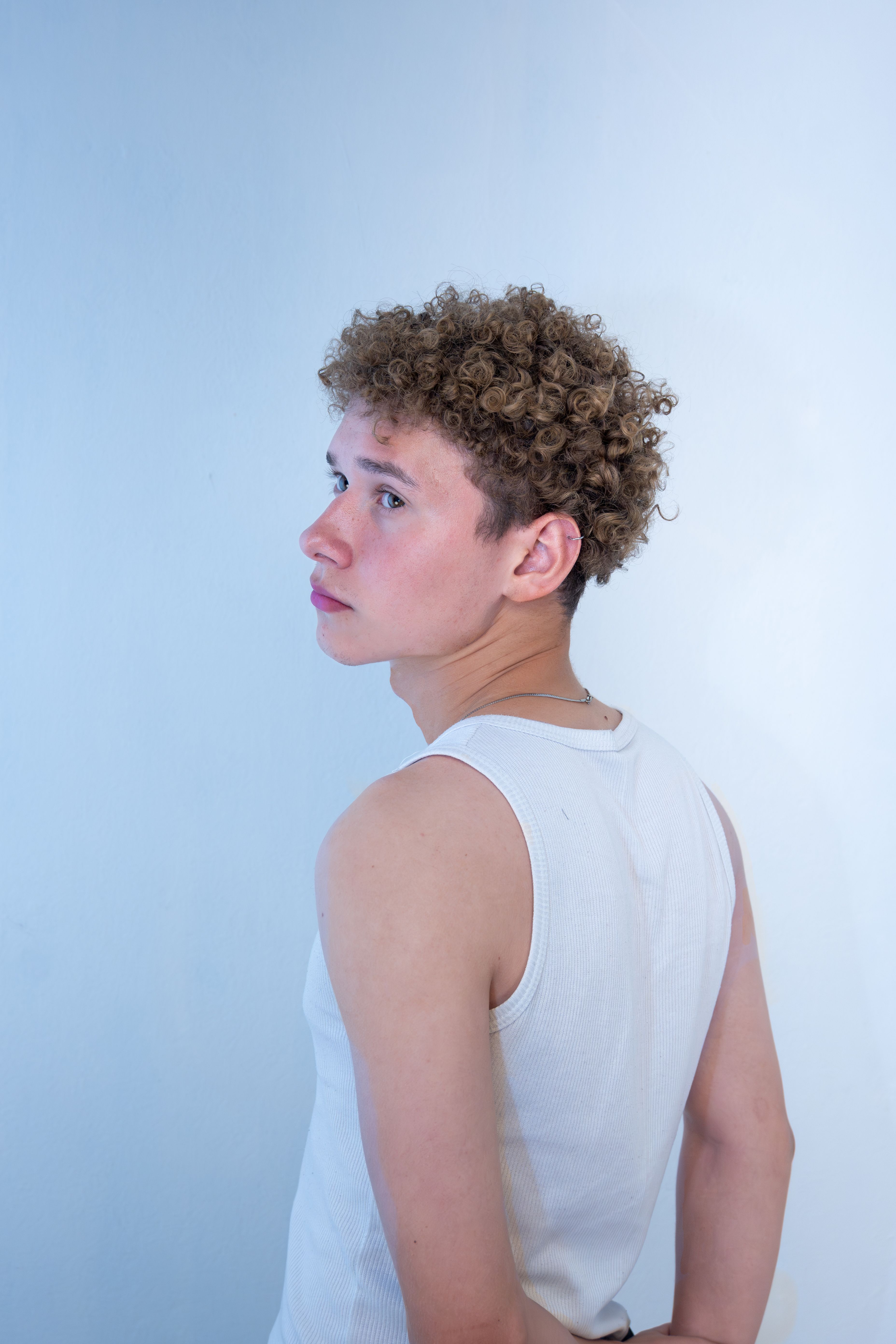 Stylish Portrait of Young Man with Curly Hair · Free Stock Photo