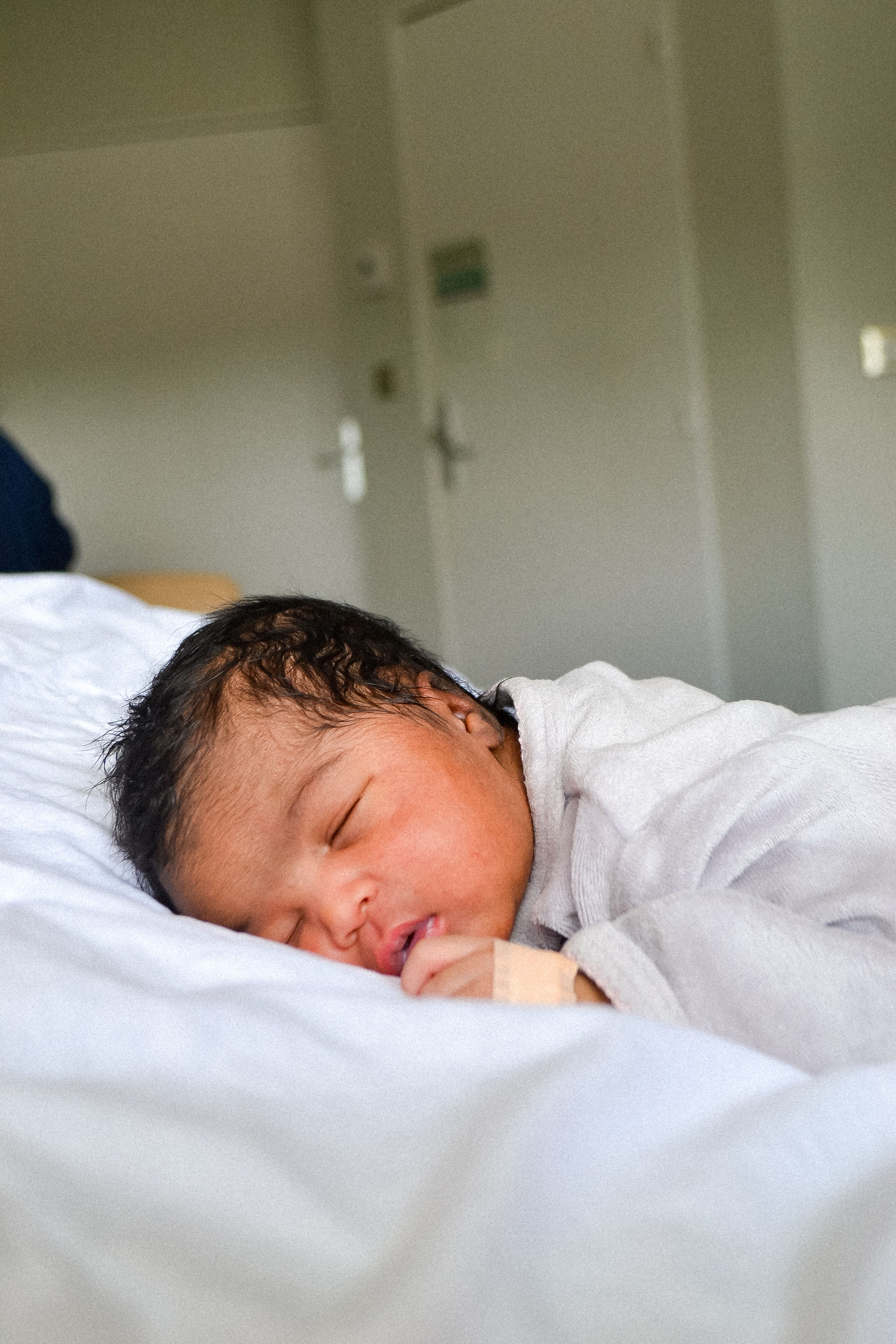 A peaceful newborn baby sleeping indoors, showcasing the innocence and tranquility of early life.