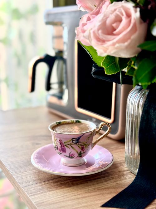 Free A decorative cup of Turkish coffee beside fresh roses, capturing an elegant morning vibe. Stock Photo
