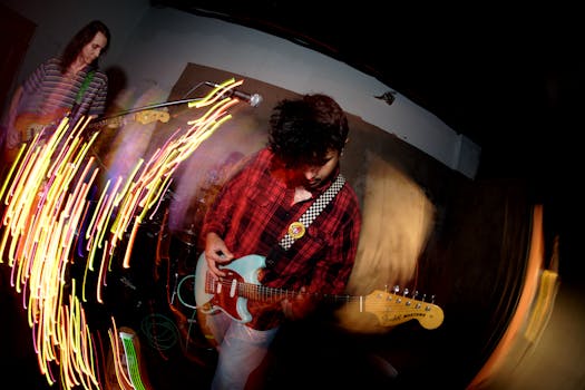 Energetic live band performance capturing movement and musical passion with electric guitars.