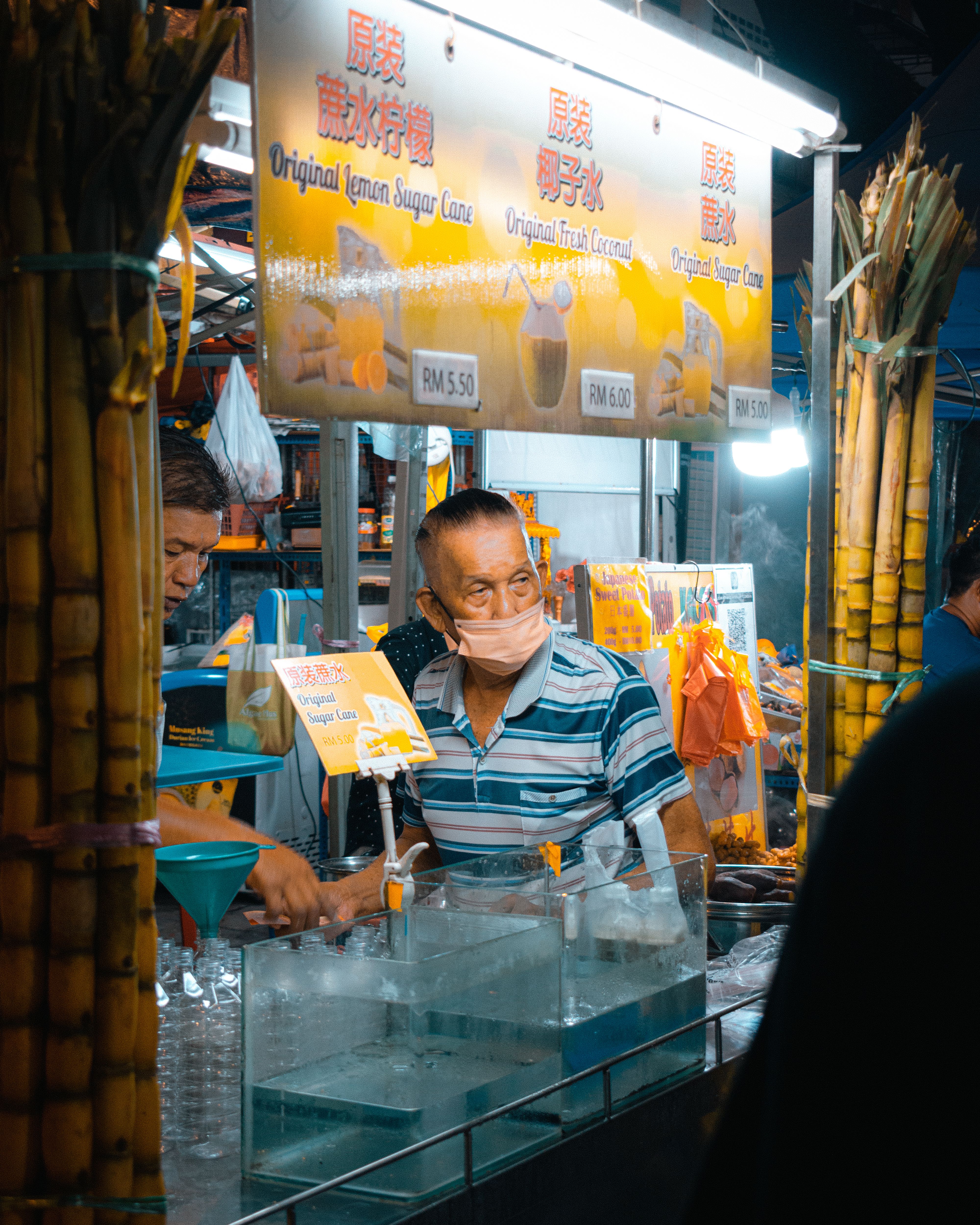 Drink stall at a Kuala Lumpur night market with colorful beverages