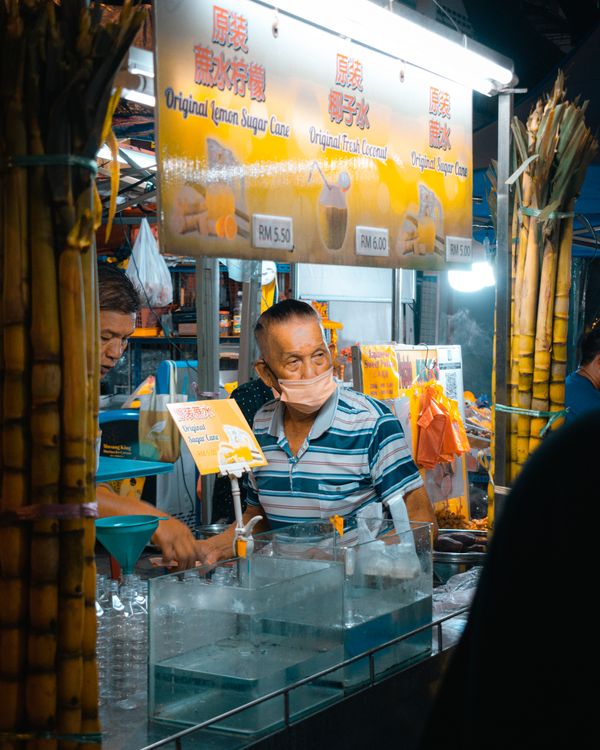 Drink stall at a Kuala Lumpur night market with colorful beverages