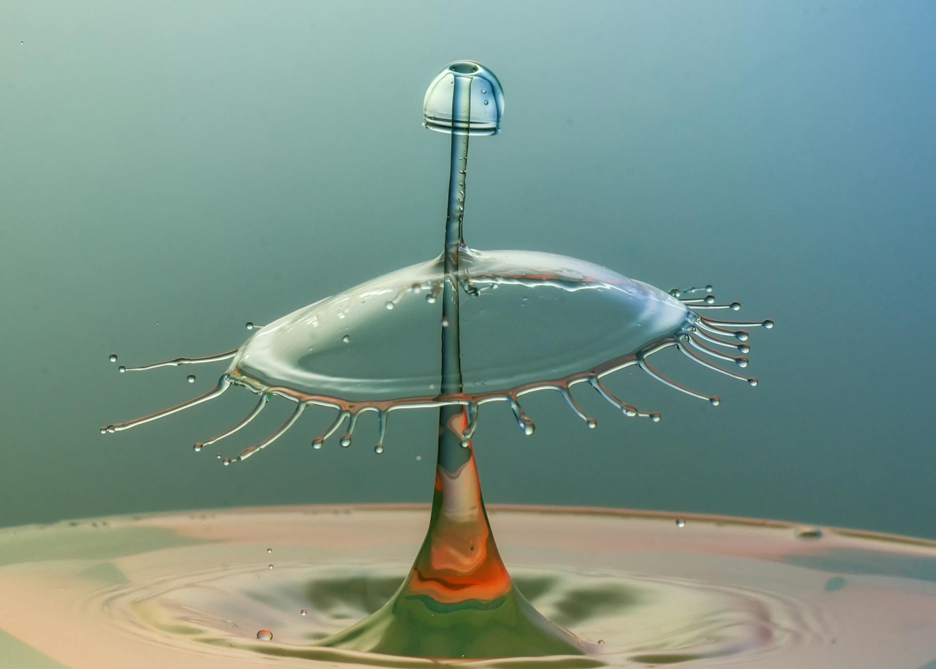 Artistic water droplet collision creating a mesmerizing splash form with vibrant colors.