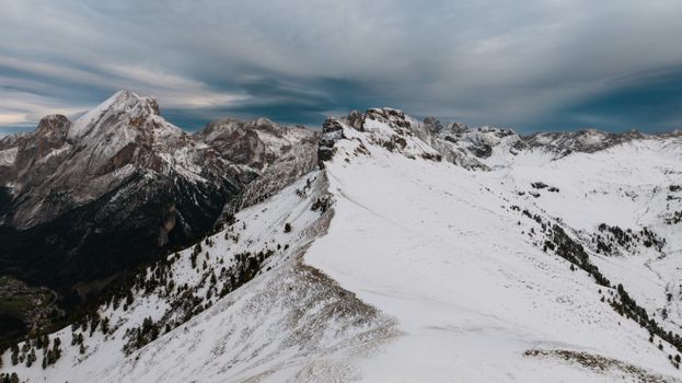 A breathtaking winter view of the Dolomites in Canazei, Italy, showcasing snow-capped peaks.