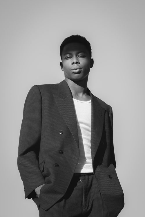 Free Black and white portrait of a man in a pinstripe suit representing urban fashion. Stock Photo