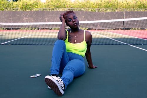 Photo Of Woman Sitting On Tennis Court