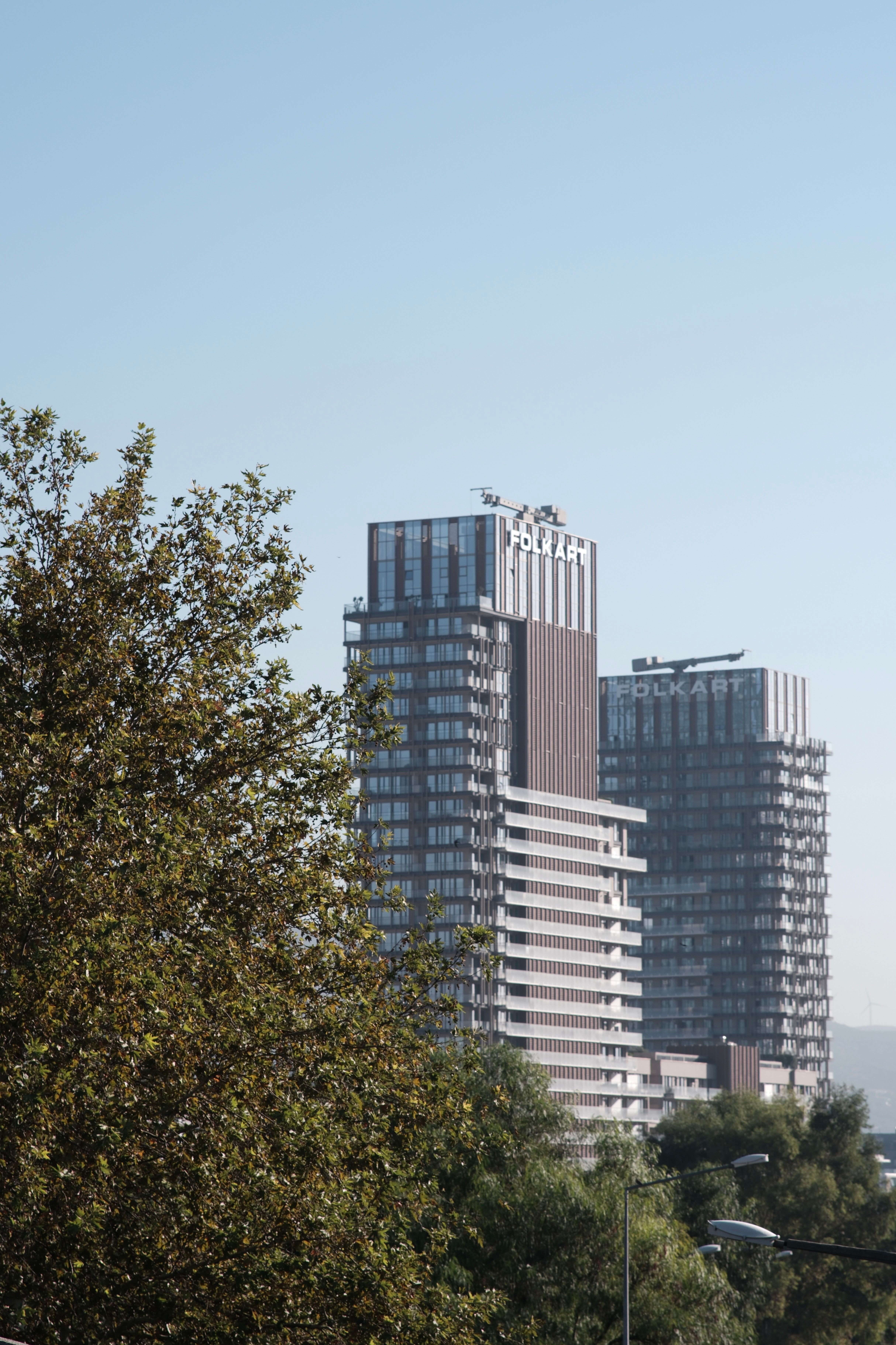 View of modern skyscrapers in Bornova, İzmir with clear blue sky.