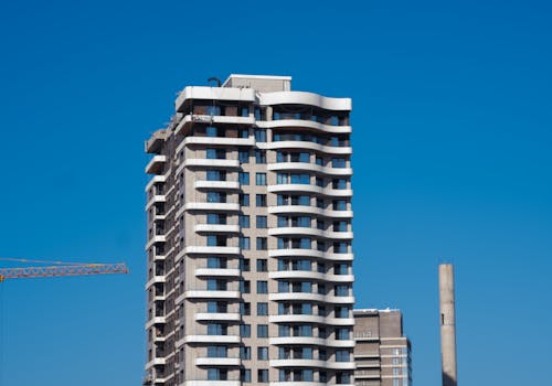 A view of a contemporary high-rise building against a clear blue sky in Bornova, İzmir, Türkiye.