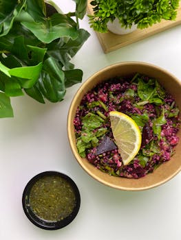 Vibrant beetroot salad with fresh greens and a lemon slice, perfect for a healthy meal.