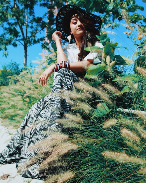 Photo Of Woman Sitting Beside Plants