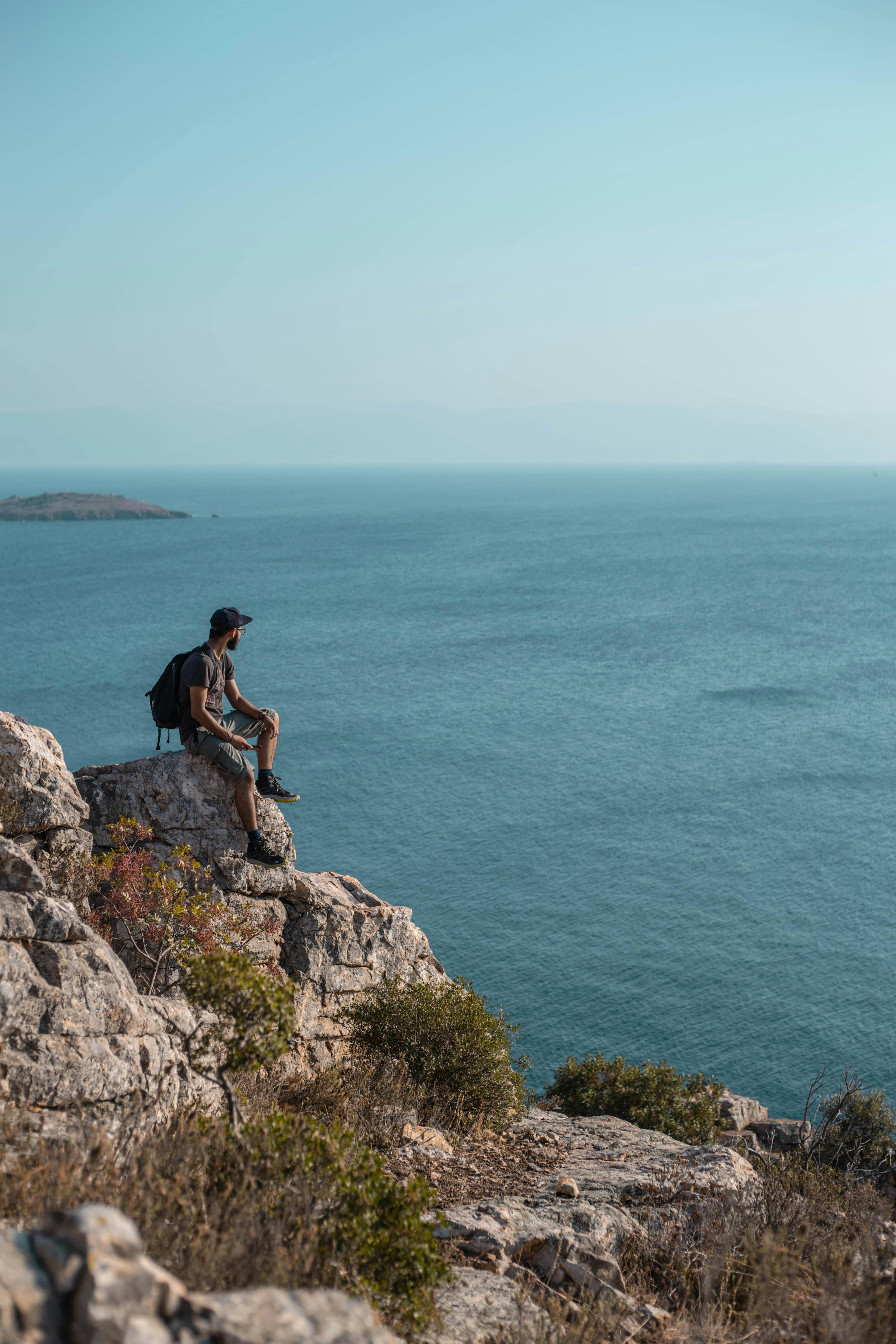 Man Sitting On Cliff