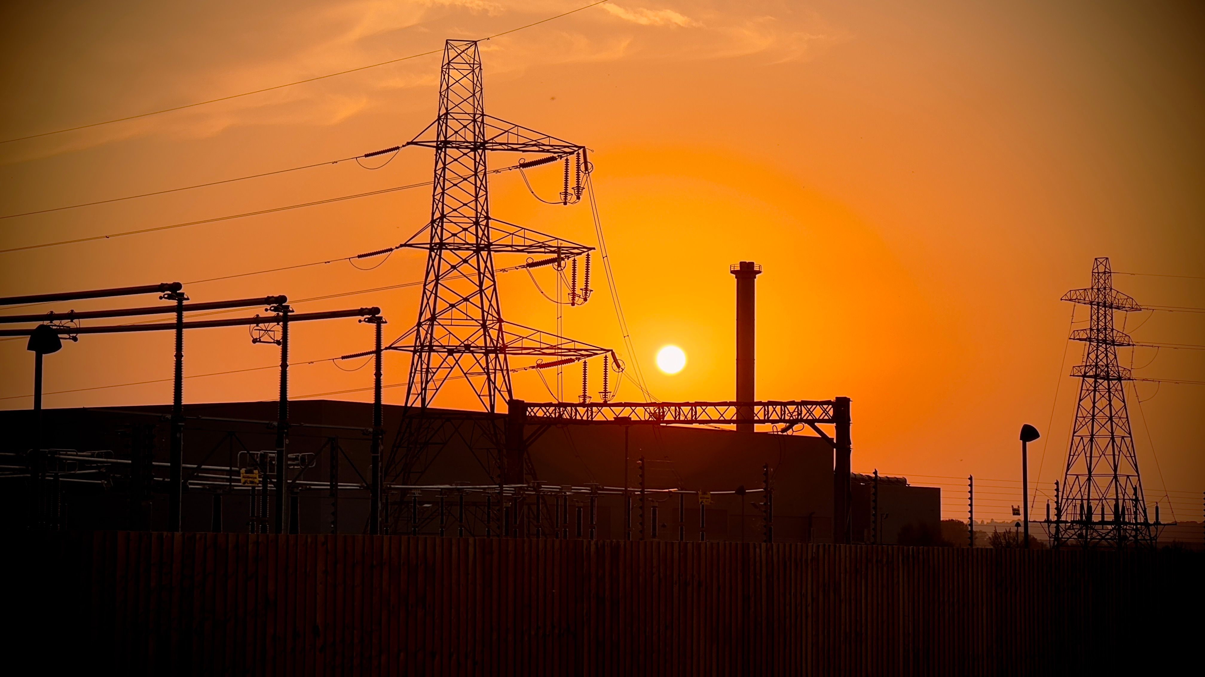 Industrial Landscape at Sunset with Power Lines · Free Stock Photo