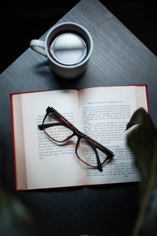 Free Black Framed Eyeglasses On Book Stock Photo