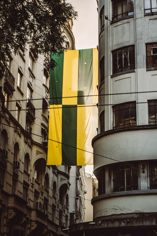 Green and Yellow Banner On Building