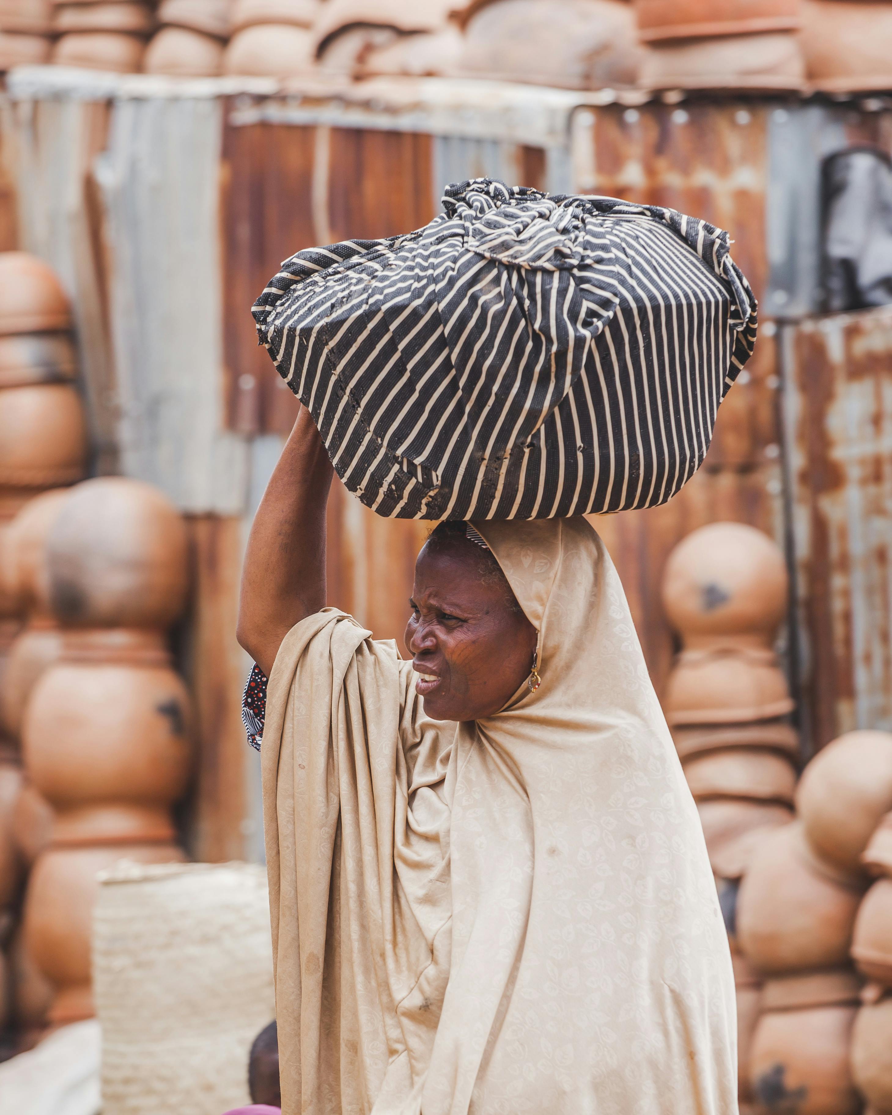 woman carrying bundle in traditional market