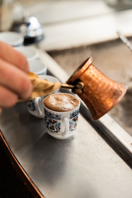 Free Freshly brewed Turkish coffee in a cezve with ornamental cups in Istanbul, Türkiye. Stock Photo