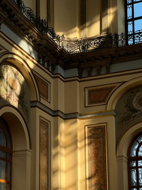 Free Sunlight casting intricate shadows inside a grand, historic building. Stock Photo