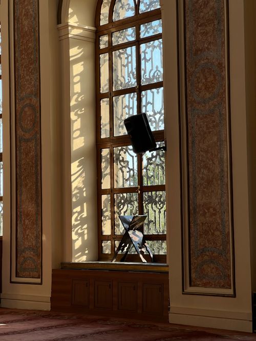 Free Sunlight streams through an ornate window casting intricate shadows indoors. Stock Photo