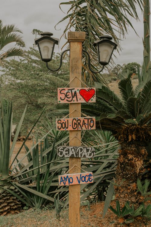 Free Rustic wooden signpost with inspirational messages in a tropical setting. Stock Photo