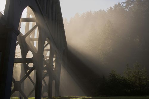 Free Sunlight beams through the arches of a historic bridge at Heceta Beach, Oregon Coast. Stock Photo