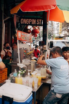 Bustling street food stall in Ongpin Street, a lively market with people enjoying local delicacies.