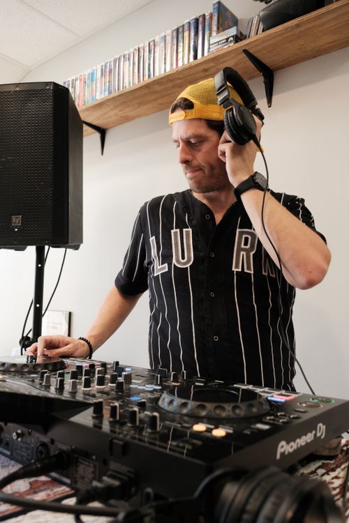 Free DJ mixing music at an indoor event in Gainesville, FL with professional equipment. Stock Photo