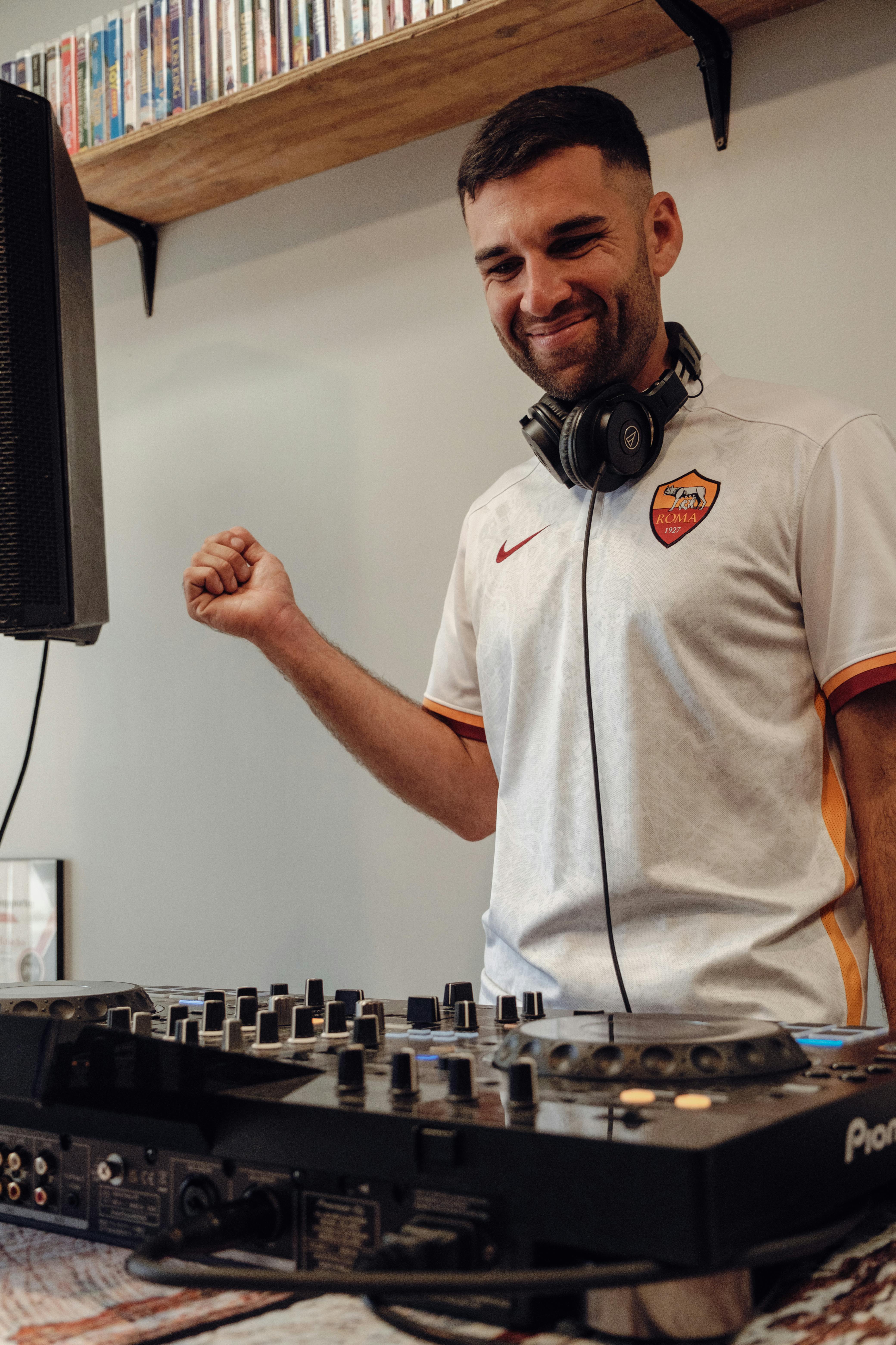 Energetic DJ mixing tracks at a music event in Gainesville, FL.