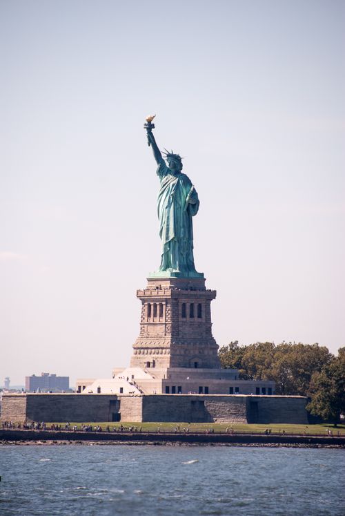 Free The iconic Statue of Liberty standing proudly against a clear sky in New York City. Stock Photo
