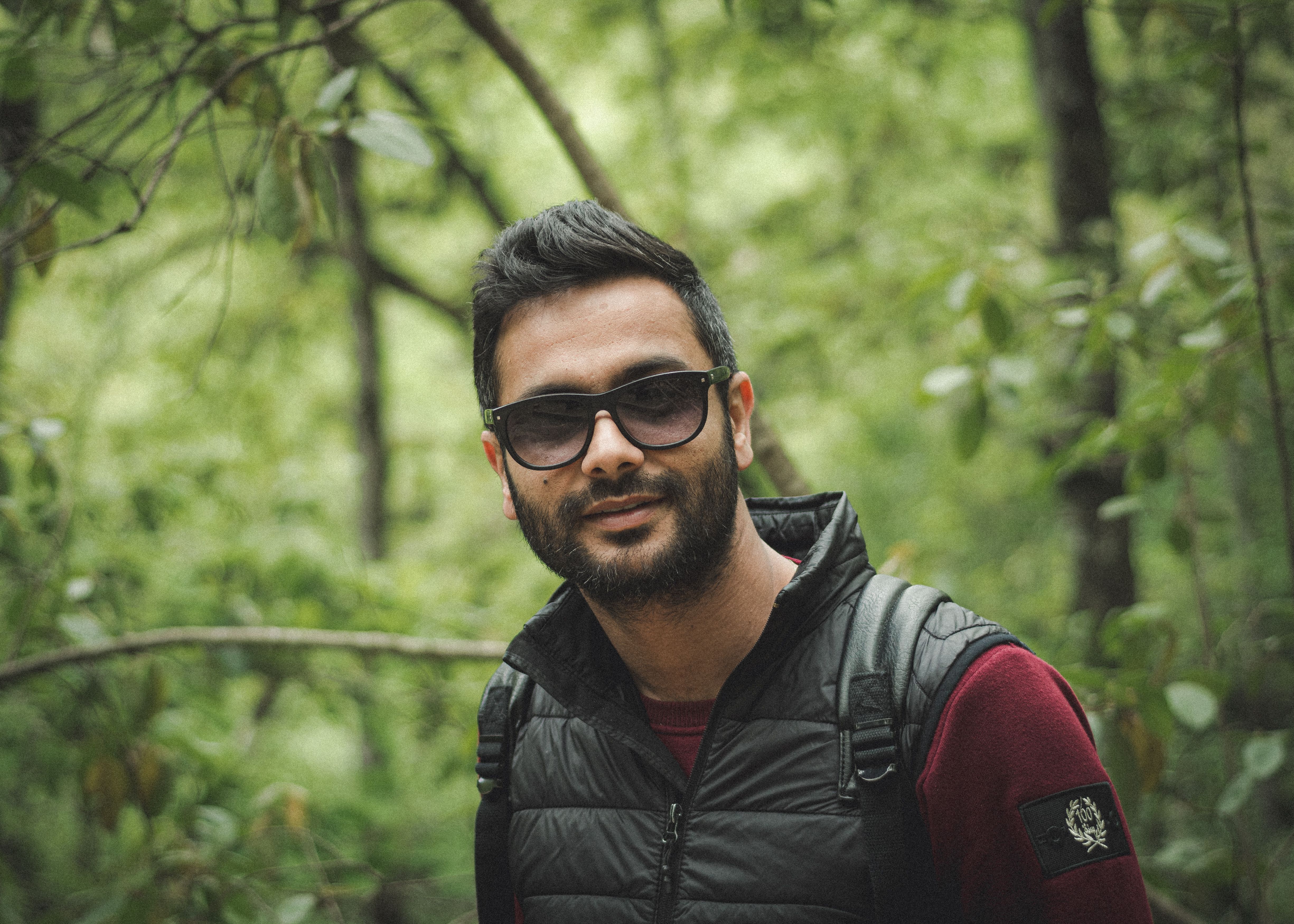 A man with sunglasses in a lush forest at Beni M Tir, Tunisia.