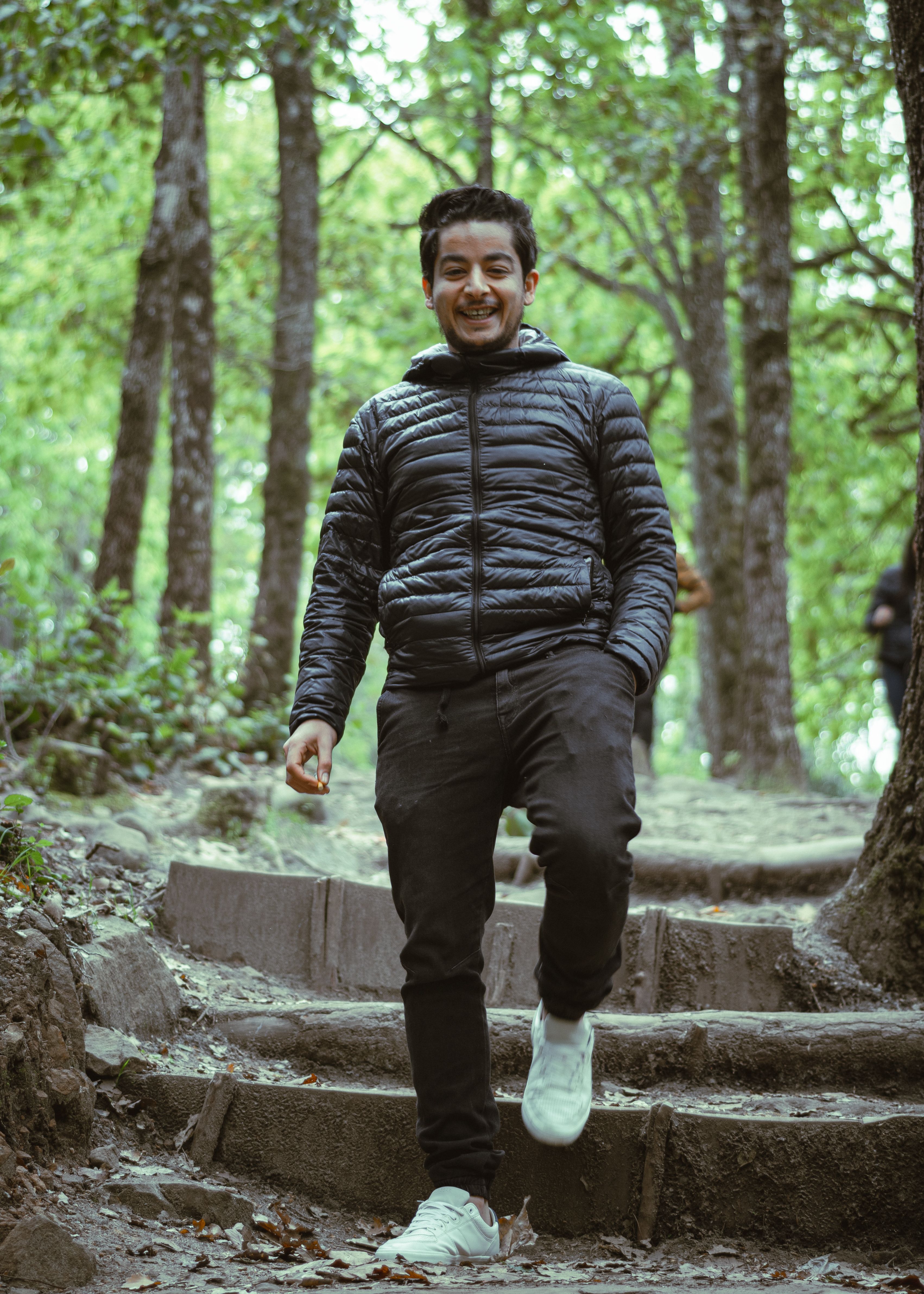Young man in a forest, enjoying a walk in Beni M Tir, Tunisia.