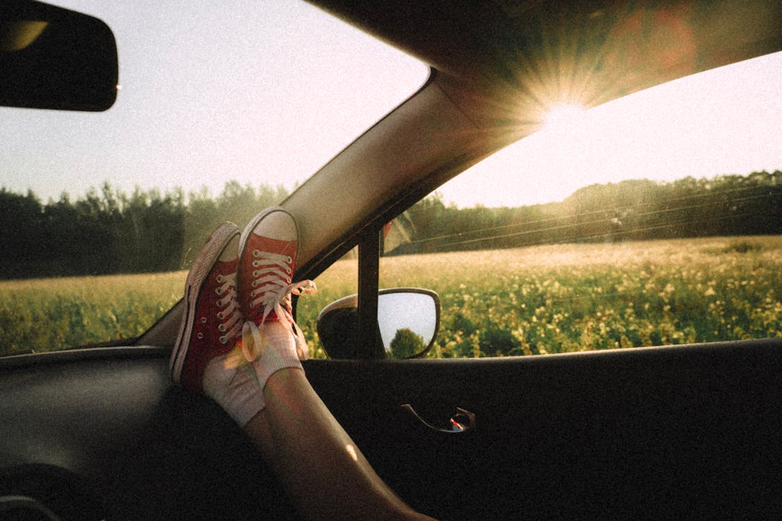 Free Person In A Vehicle With Legs Stretched On the Dashboard Stock Photo