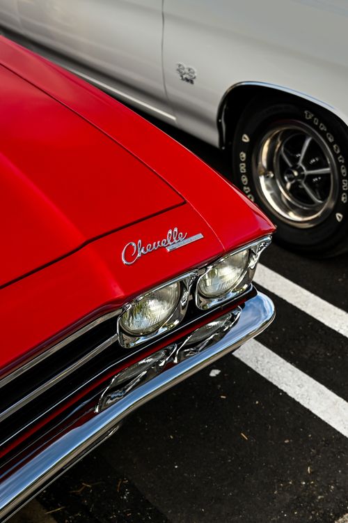 Free Close-up of a classic red Chevelle car parked in a lot. Stock Photo