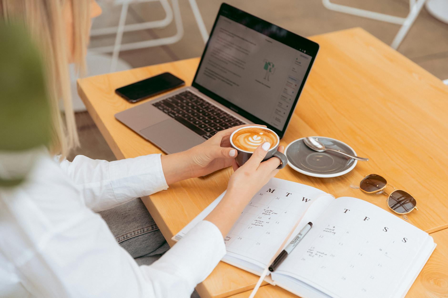 https://www.pexels.com/photo/young-woman-planning-her-schedule-with-coffee-28471098/